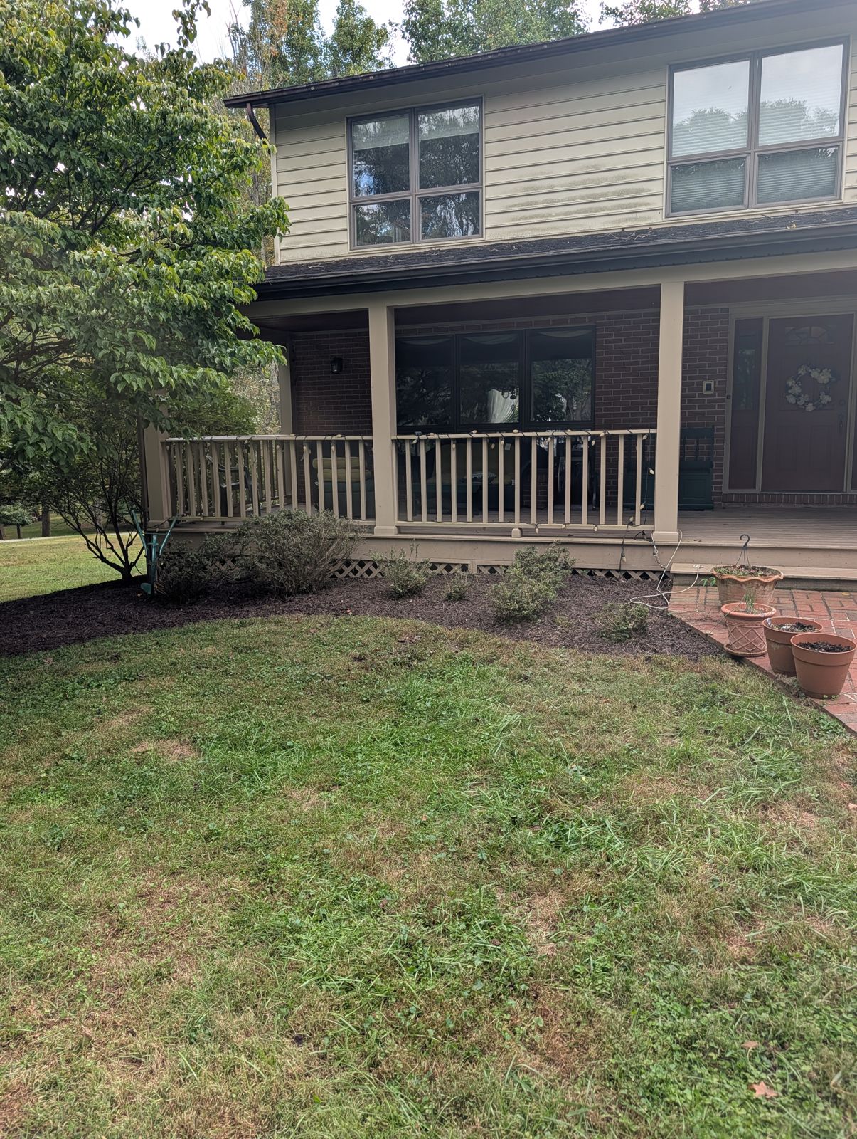 Front porch and mulch beds after a property cleanup