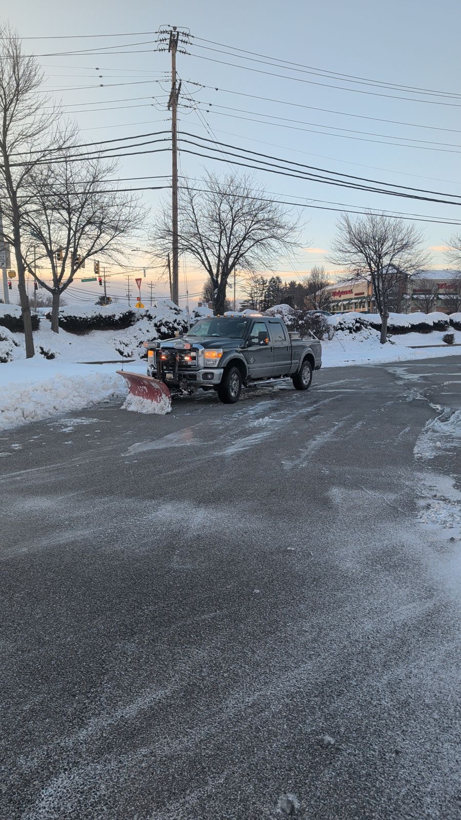 Plow truck in a snowy lot