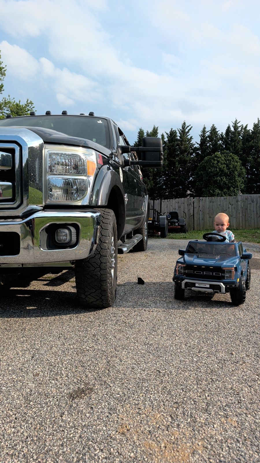 Lucas&rsquo;s son in a toy Ford truck next to a Ford Super Duty